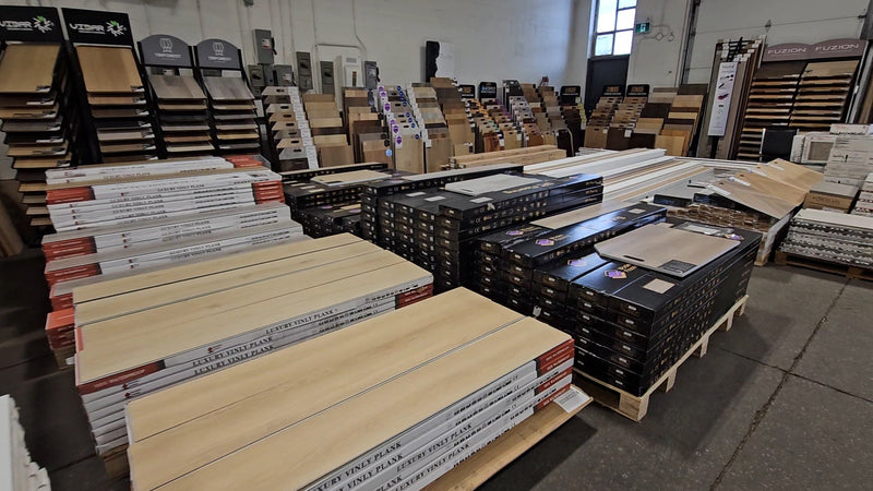 Vinyl, laminate, and engineered hardwood flooring section inside Balance Flooring's Toronto showroom