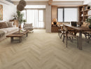 Harvest maple herringbone LVP installed in a modern living room with wooden flooring, furniture, and decor.