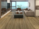 Morning Grove 9mm waterproof luxury vinyl plank flooring installed in a modern living room with wooden flooring, furniture, and a view of the ocean.