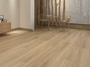 Sahara Oak vinyl plank flooring installed in modern living room with a small table and chairs.